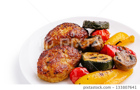 Juicy meatballs served with grilled vegetables on a white plate Juicy meatballs served with grilled vegetables on a white plate 133807641