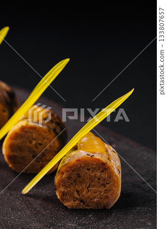 Unique culinary creation with vibrant garnishes on a dark surface Unique culinary creation with vibrant garnishes on a dark surface 133807657
