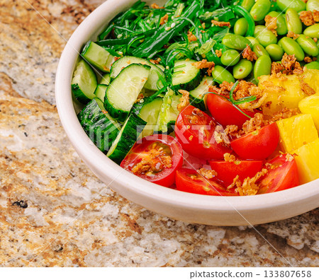 Fresh and colorful salad bowl with vegetables and fruits for healthy eating Fresh and colorful salad bowl with vegetables and fruits for healthy eating 133807658