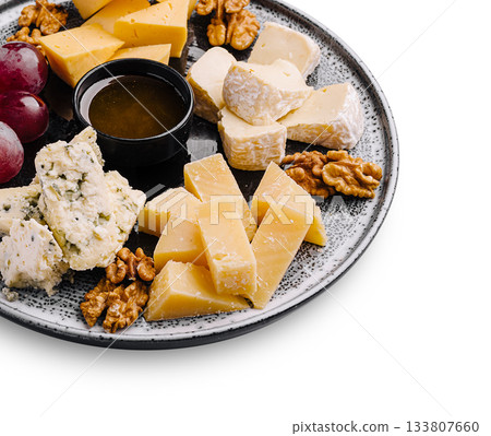 Cheese platter with assorted selections and grapes on a round plate Cheese platter with assorted selections and grapes on a round plate 133807660