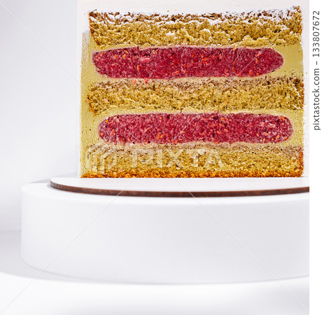 Colorful layered cake with vibrant raspberry and yellow sponge on display Colorful layered cake with vibrant raspberry and yellow sponge on display 133807672