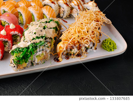 Sushi platter showcasing diverse rolls at a modern restaurant in the evening 133807685