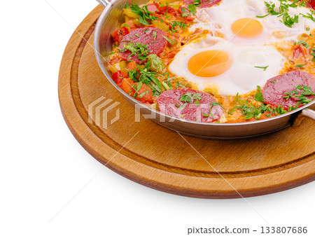 Delicious shakshuka served in a pan with fresh herbs and vegetables Delicious shakshuka served in a pan with fresh herbs and vegetables 133807686