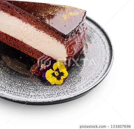 Decadent chocolate cake slice with cream filling and edible flowers Decadent chocolate cake slice with cream filling and edible flowers 133807696