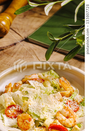 Fresh shrimp salad served on a wooden table with green decor Fresh shrimp salad served on a wooden table with green decor 133807728