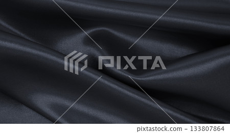 Smooth elegant dark grey silk or satin luxury cloth texture as abstract background. Luxurious background design Smooth elegant dark grey silk or satin luxury cloth texture as abstract background. Luxurious background design 133807864