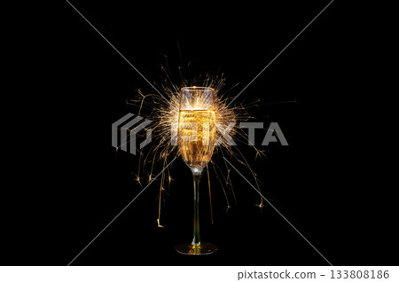 Champagne Glass with Sparkler Explosion on Black Background 133808186