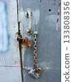 A steel chain hangs from above. Gate opening chain. Gate in the garage. 133808356