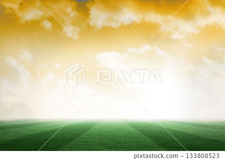 Football pitch under yellow sky 133808523