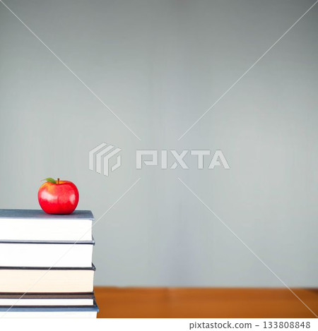 Red apple on pile of books in classroom 133808848
