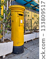 Yellow Cypriot pillar box next to a parcel locker 133809517