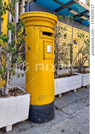 Yellow Cypriot pillar box next to a parcel locker Yellow Cypriot pillar box next to a parcel locker 133809517