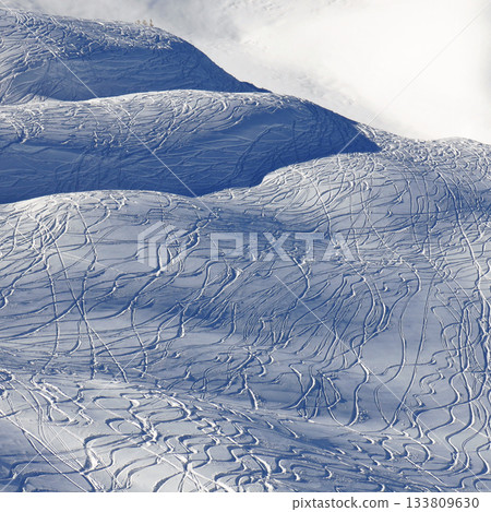 Hill covered by ski and snowboard tracks, Stoos ski area, SWitzerland. 133809630