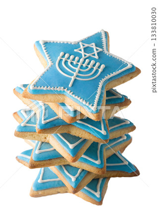 Delicious stack of hanukkah star-shaped sugar cookies decorated with menorah and star of david, sweet traditional holiday treat Delicious stack of hanukkah star-shaped sugar cookies decorated with menorah and star of david, sweet traditional holiday treat 133810030