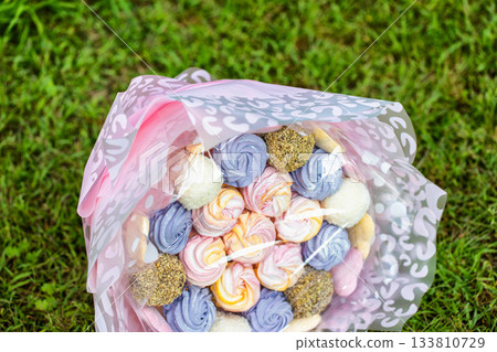 Gift set of marshmallows and sweets on green grass, close-up. Sweet food 133810729