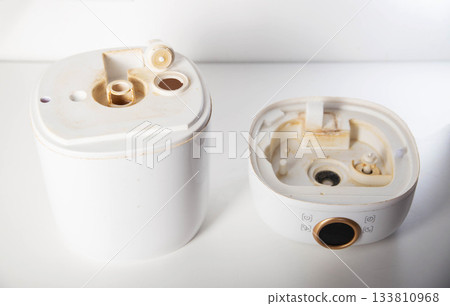 Dirty humidifier from hard water and mold. Hard water and scale, rust in white humidifier, close-up 133810968