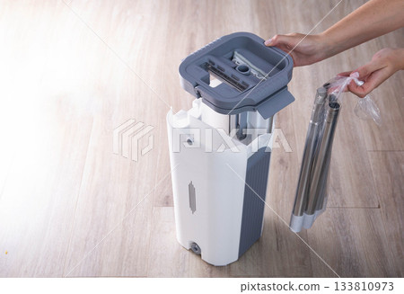 Assembling a bucket with a modern mop with a wringer for easy cleaning. Copy space for text, rinsing the mop 133810973