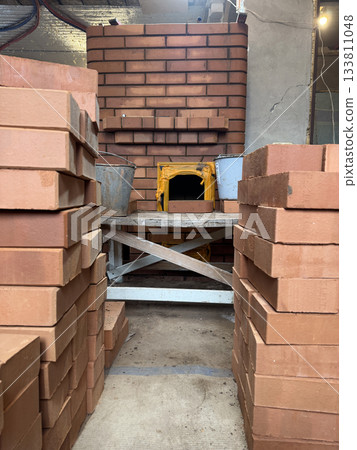 Construction of a heating stove. Nearby are the stove fitters scaffolding and materials. 133811048