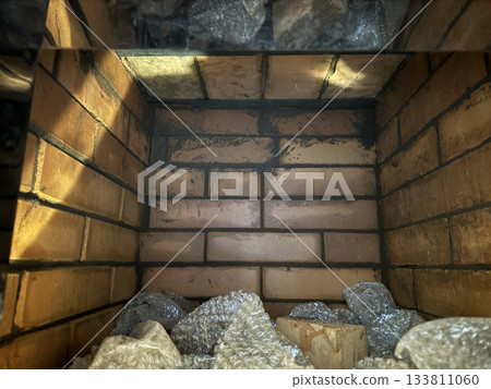 Brickwork of a heating stove. Plate with an oven inside. Brickwork of a heating stove. Plate with an oven inside. 133811060