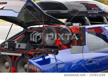 Elaborate Powerful Sound System Showcased From Open Rear Of Car. Large Speakers Are Mounted In Custom Enclosures. 133811293