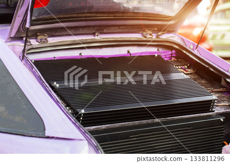 High-Power Car Audio Amplifiers Installed In Modified Purple Automobile. Sound System Electronics Are Mounted In Trunk. 133811296