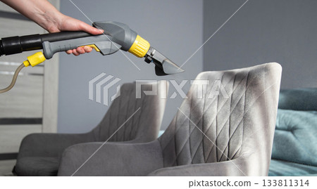 Deep cleaning of upholstered furniture at home using a steam cleaner for better hygiene and appearance 133811314