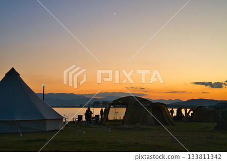 Dusk camp and crescent moon Dusk camp and crescent moon 133811342