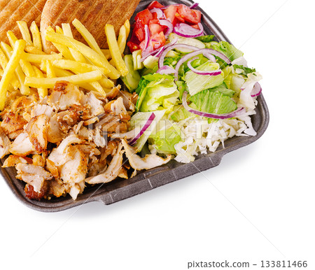 Delicious meal featuring chicken, fries, salad, and pita bread served together Delicious meal featuring chicken, fries, salad, and pita bread served together 133811466