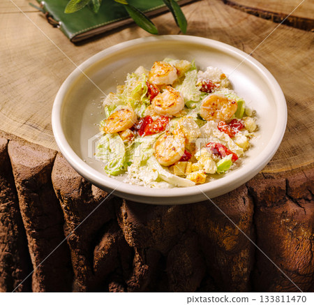 Fresh shrimp salad with greens and tomatoes on a wooden table 133811470