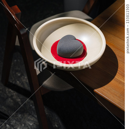 Modern heart-shaped dessert with black coating and red sauce Modern heart-shaped dessert with black coating and red sauce 133811503