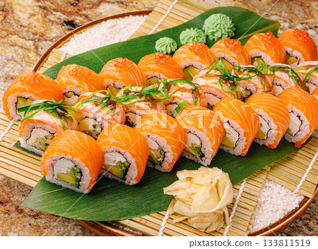 Freshly made sushi platter with salmon and avocado served on bamboo 133811519