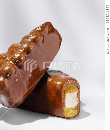 Delicious chocolate-coated dessert bars with a creamy filling and crunchy base Delicious chocolate-coated dessert bars with a creamy filling and crunchy base 133811523