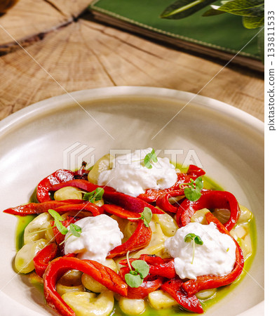 Colorful dish with roasted peppers and creamy toppings served in a bowl Colorful dish with roasted peppers and creamy toppings served in a bowl 133811533