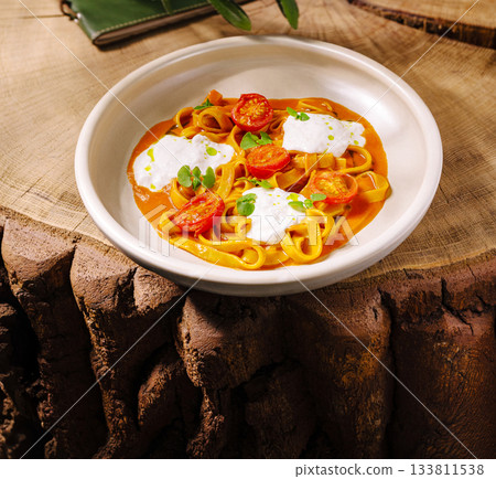 Delicious homemade pasta served on rustic wooden table Delicious homemade pasta served on rustic wooden table 133811538