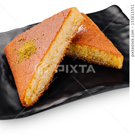 Traditional dessert served on a black plate at a cultural event Traditional dessert served on a black plate at a cultural event 133811551