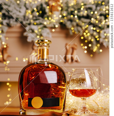 Elegant bourbon and glass set against festive holiday decor with lights Elegant bourbon and glass set against festive holiday decor with lights 133811612