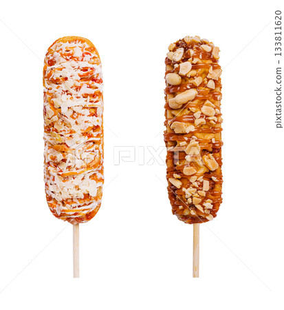 Colorful dessert pops on sticks with coconut and peanuts Colorful dessert pops on sticks with coconut and peanuts 133811620
