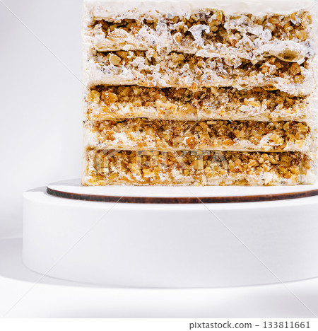 Layered nut and cream dessert on a tasting stand 133811661