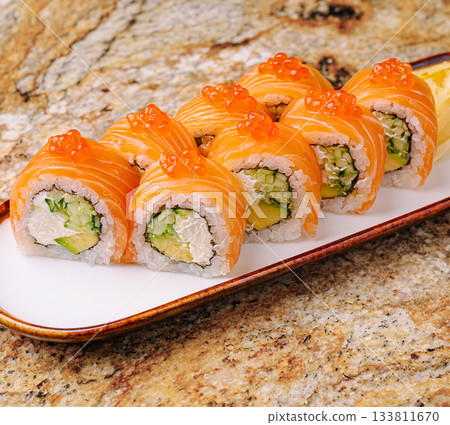 Colorful sushi rolls arranged neatly on a plate ready to be enjoyed Colorful sushi rolls arranged neatly on a plate ready to be enjoyed 133811670