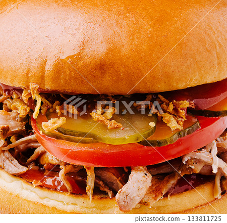 Delicious pulled pork sandwich with toppings ready to be enjoyed 133811725
