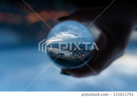 Blue sky reflected in a glass ball Blue sky reflected in a glass ball 133811781