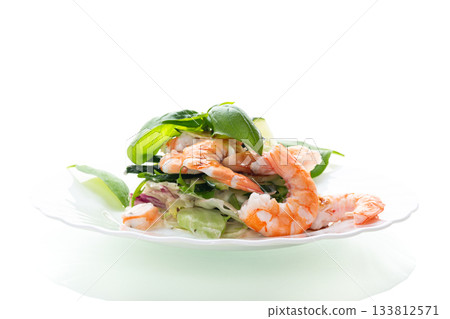 Appetizing salad with shrimps on a white background Appetizing salad with shrimps on a white background 133812571