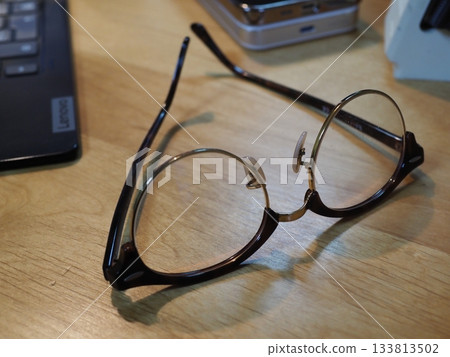 Glasses on a desk. Copy space. Image suitable for business. Coffee break with glasses. Glasses on a desk. Copy space. Image suitable for business. Coffee break with glasses. 133813502
