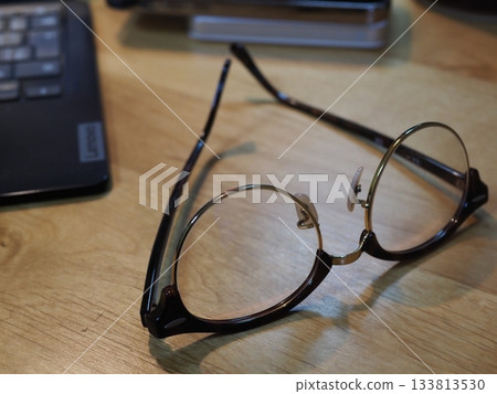 Glasses on a desk. Copy space. Image suitable for business. Coffee break with glasses. Glasses on a desk. Copy space. Image suitable for business. Coffee break with glasses. 133813530