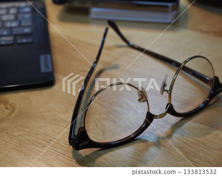 Glasses on a desk. Copy space. Image suitable for business. Coffee break with glasses. Glasses on a desk. Copy space. Image suitable for business. Coffee break with glasses. 133813532