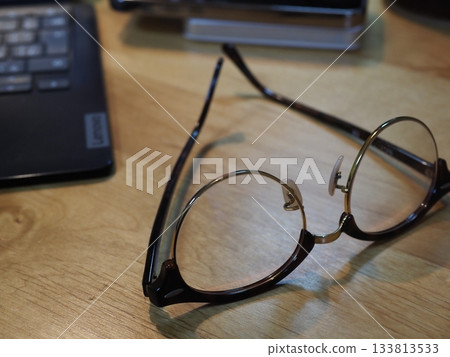 Glasses on a desk. Copy space. Image suitable for business. Coffee break with glasses. Glasses on a desk. Copy space. Image suitable for business. Coffee break with glasses. 133813533
