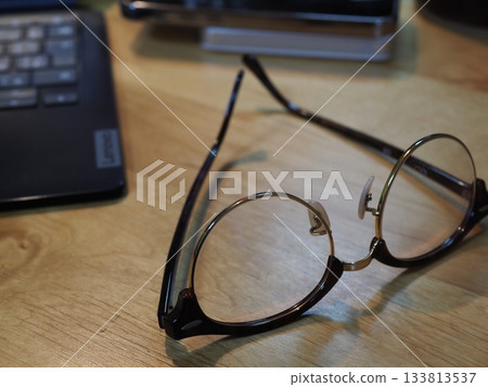 Glasses on a desk. Copy space. Image suitable for business. Coffee break with glasses. Glasses on a desk. Copy space. Image suitable for business. Coffee break with glasses. 133813537