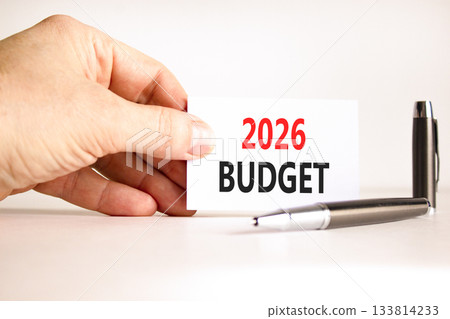 2026 Budget symbol. Concept words 2026 Budget on beautiful white card. Beautiful white paper background. Businessman's hand. Business and 2026 budget concept. Copy space. 133814233