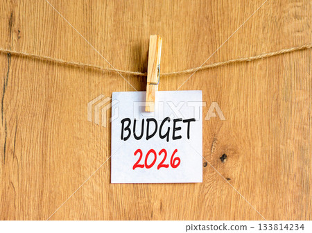 Budget 2026 symbol. Concept words Budget 2026 on beautiful white paper on wooden clothespin. Beautiful wooden background. Business and budget 2026 concept. Copy space. 133814234