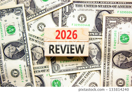 2026 Review symbol. Concept words 2026 Review on beautiful wooden blocks. Beautiful dollar bills background. Dollar bills. Business and 2026 review concept. Copy space. 133814240